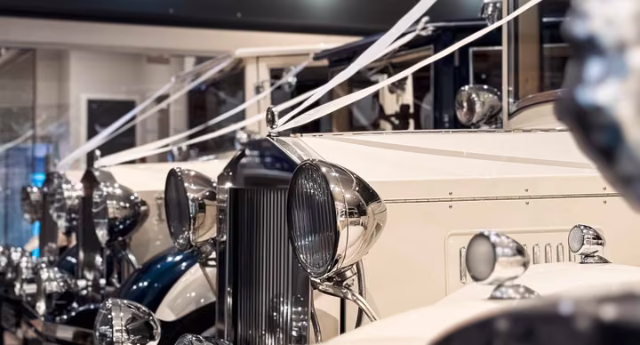 Ivory and navy Imperial wedding cars displayed inside the Keyhole Motors showroom