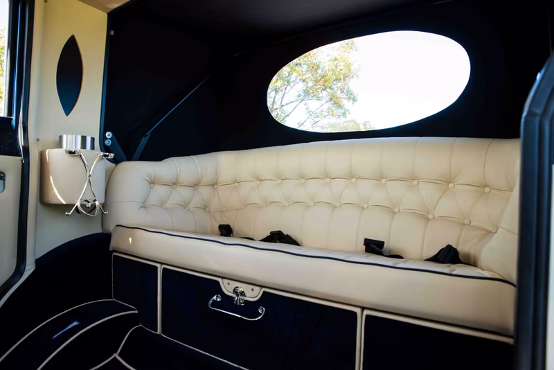 Imperial ivory button-tufted rear bench with dark trim and an oval rear window.