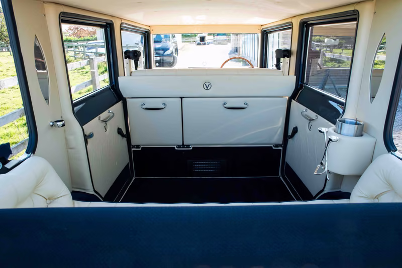 Imperial passenger cabin looking forward to the ivory partition and doors above dark carpeting.